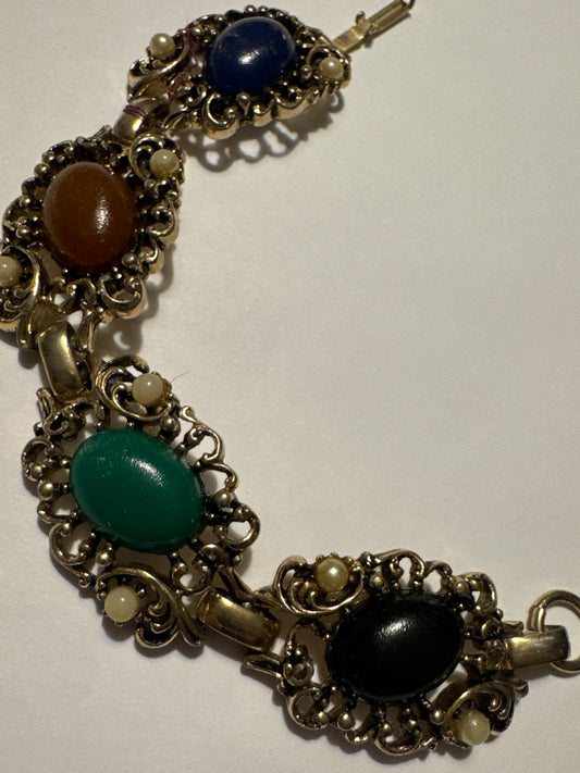 1970s gold tone bracelet with colored cabochons and faux pearls. Road