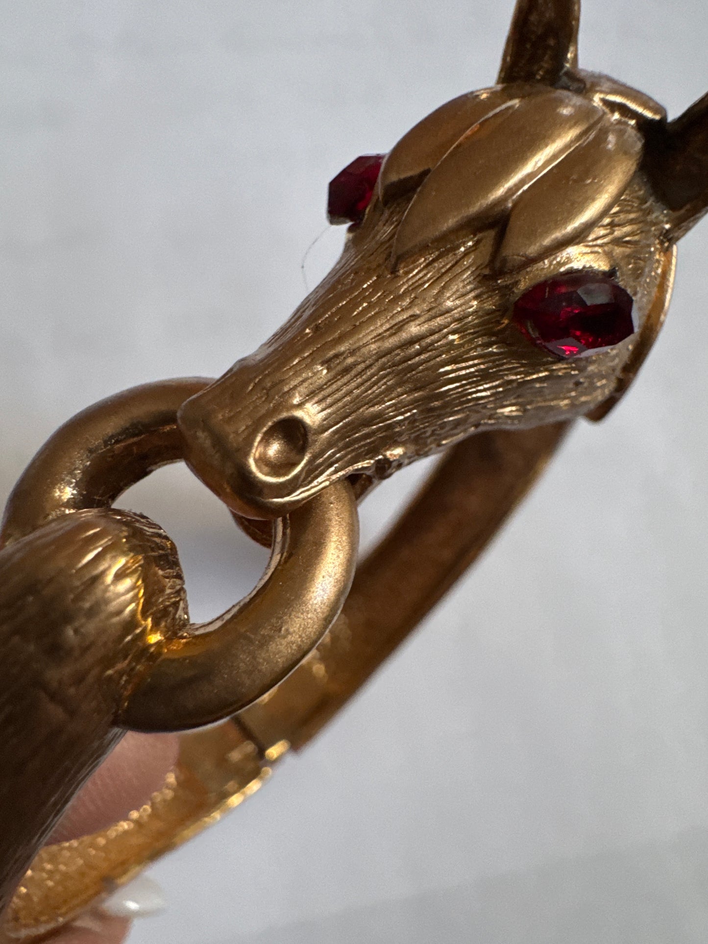 1960s signed PAULINE RADER gold tone ram clamper with ruby rhinestone eyes.