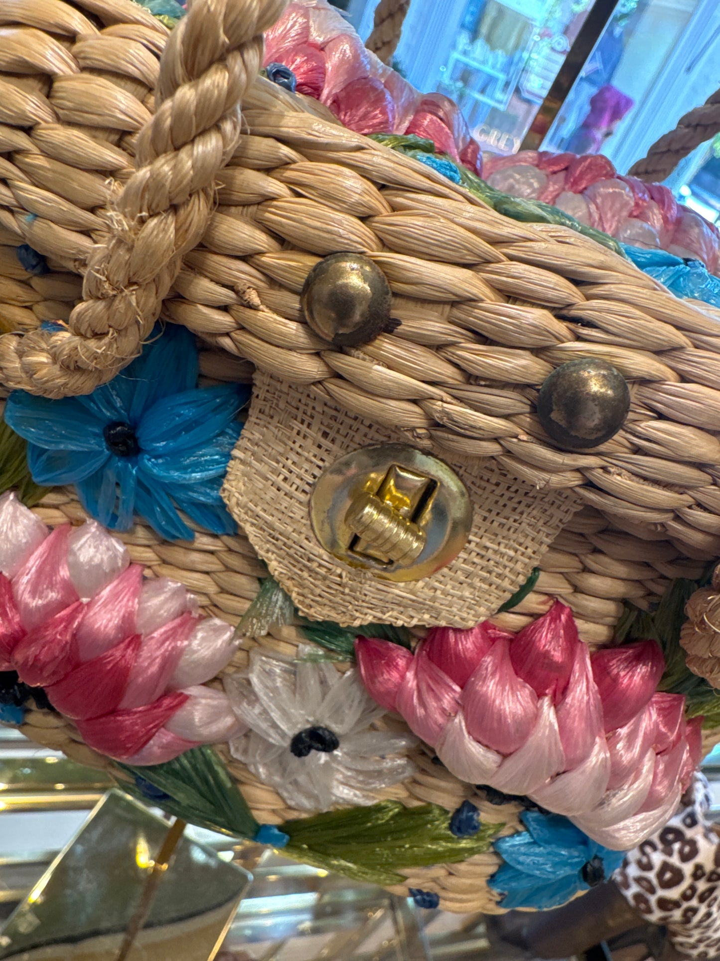 Beautiful 1960s wicker bag with pink yellow and turquoise flowers. Rope handle.