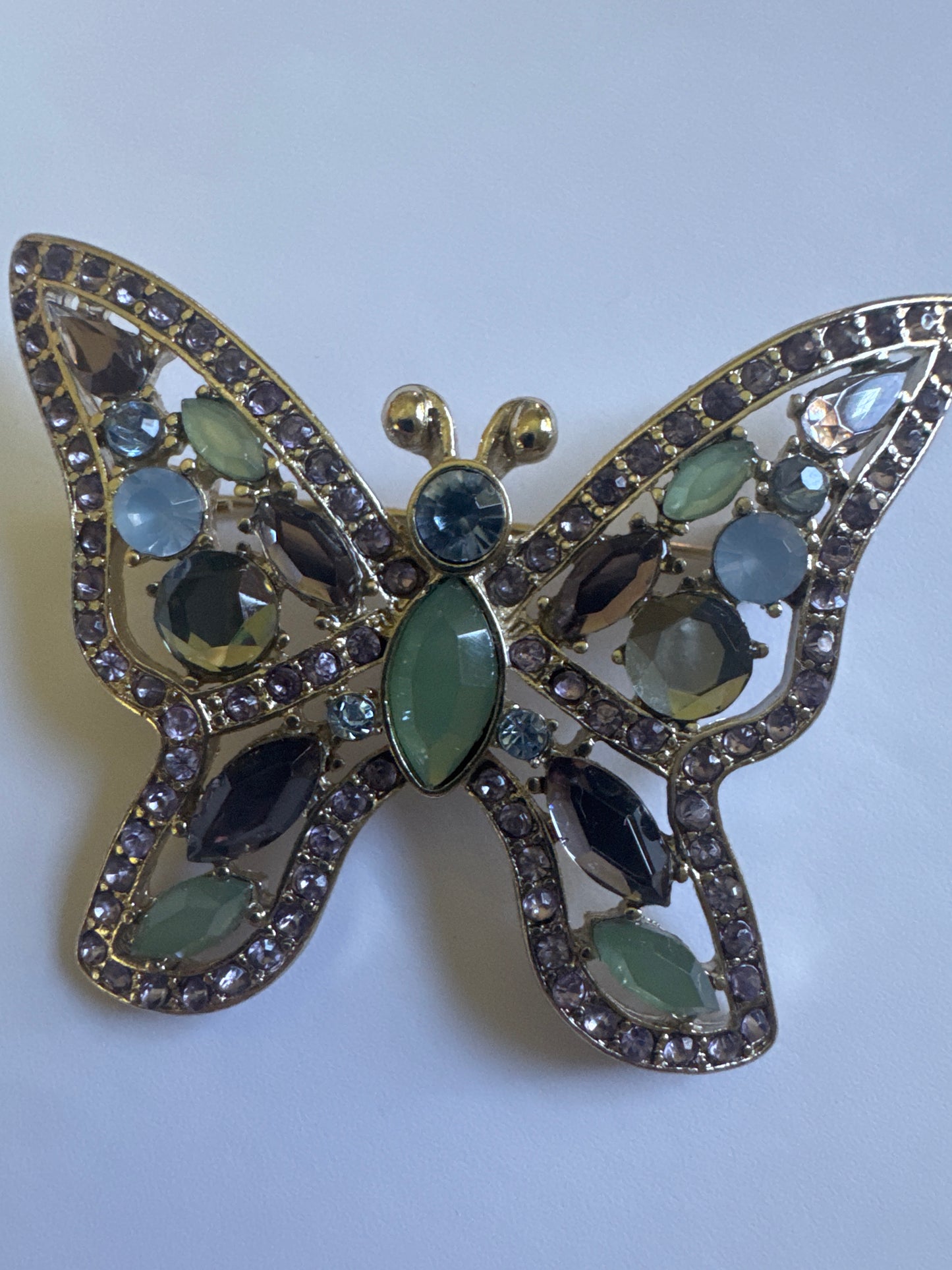1990s silver tone signed NAPIER butterfly brooch with light green and blue rhinestones