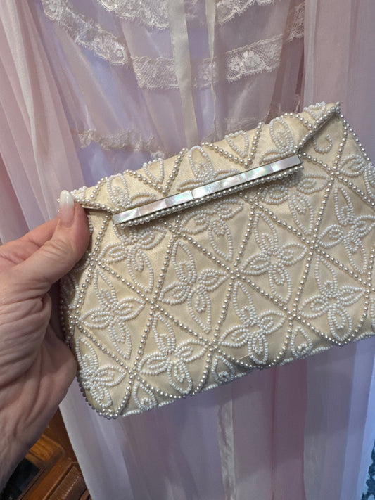 1940s beaded clutch with mother of pearl detail and pearl beading. Note back