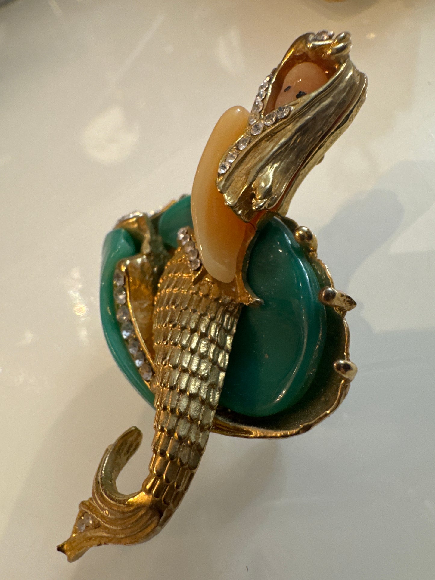 Attributed Hattie Carnagie mermaid brooch circa1960.
Carved lucite figure and wave, hand-set rhinestones, sculptural gold-tone metal. Unsigned, a strong example of mid-century fantasy figural jewelry.