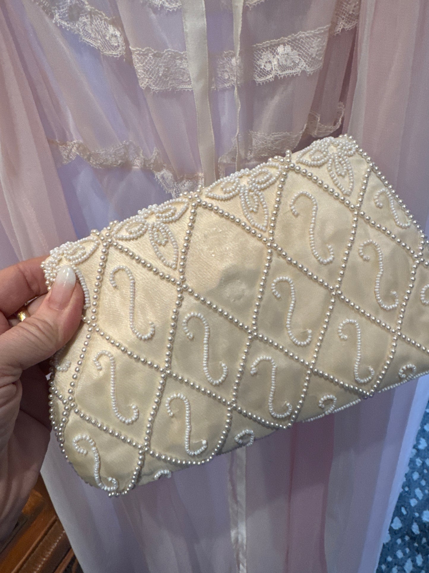 1940s beaded clutch with mother of pearl detail and pearl beading. Note back