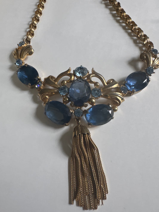 Absolutely gorgeous 1930s signed Schiaparelli necklace featuring shades of blue glass beads with tassel dangle, and J clasp closure