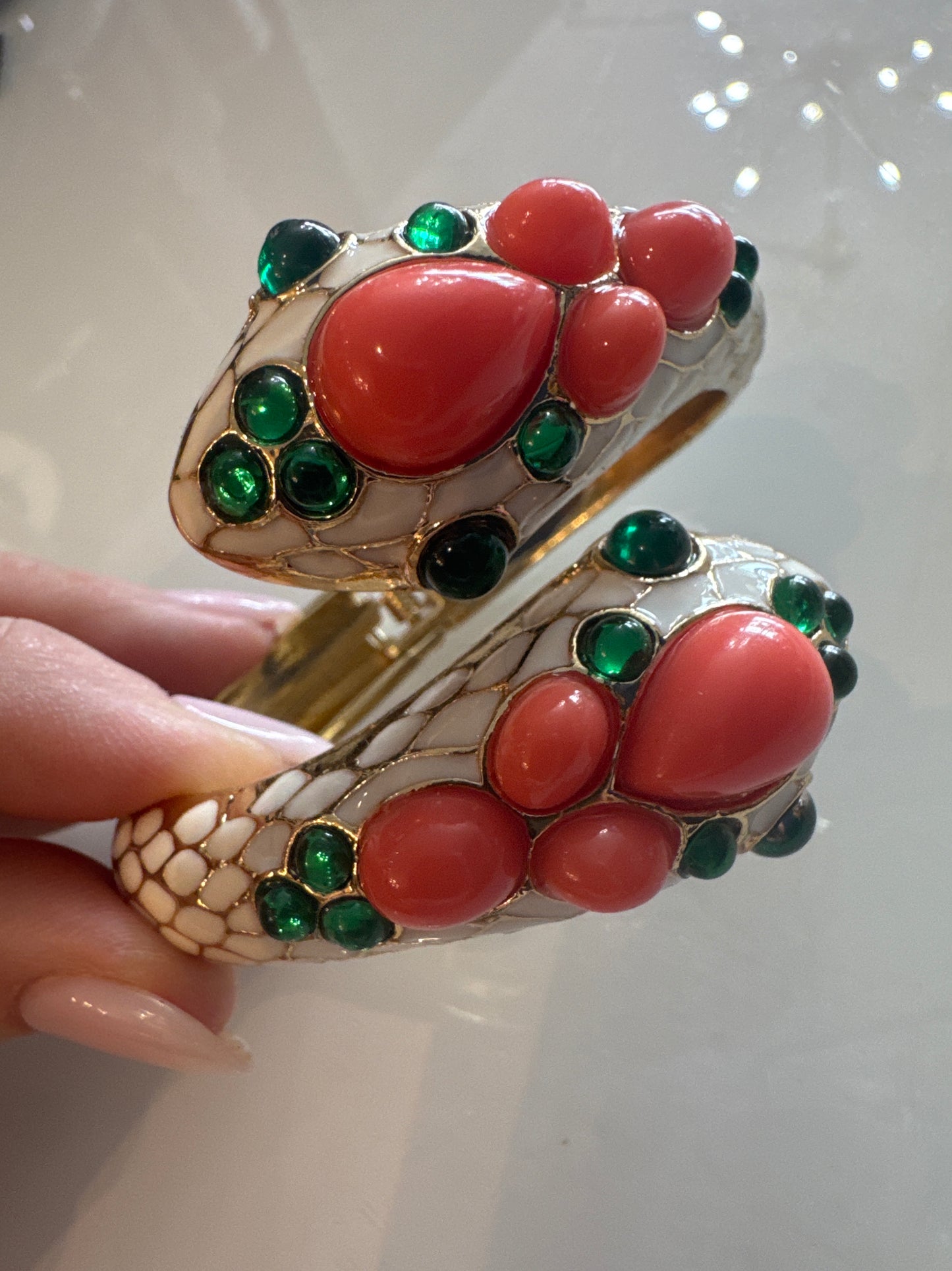 Trifari gorgeous 1968 snake clamper bracelet with green glass and faux coral cabachon stones. Unsigned from L'Orient Collection