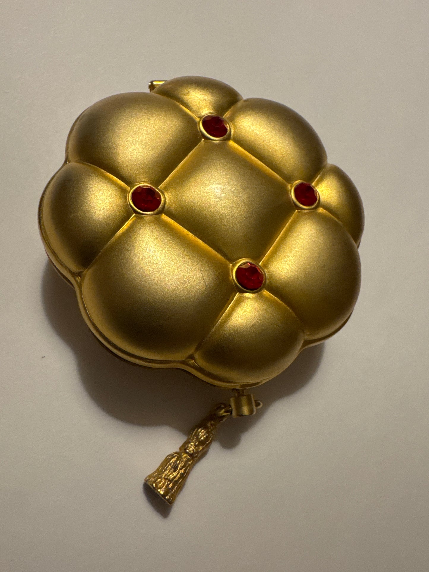 Vintage brushed gold Estée Lauder compact with red stones and tassel. Road
