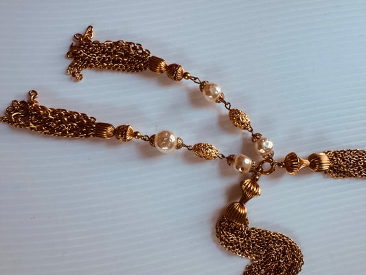 Gorgeous vintage Chanel inspired gold tone and pearl chain necklace. Tassel hangs down the back. Note some beads have chipped gold. Sourced in Paris.