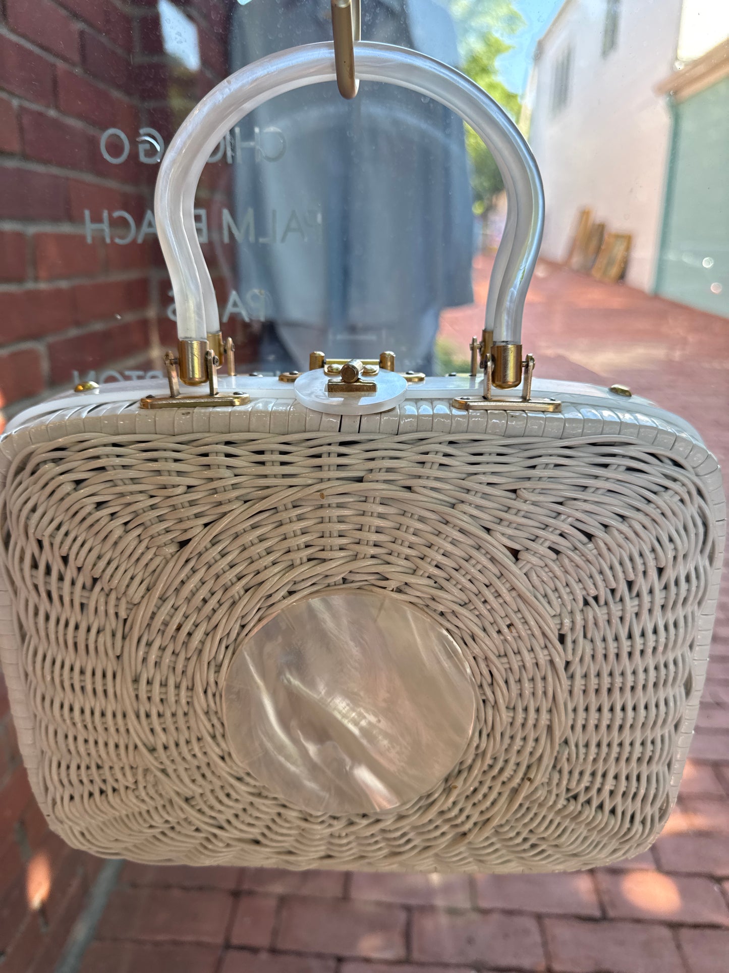 Beautiful 1950s white wicker  bag with mother of pearl in the center and lucite handles