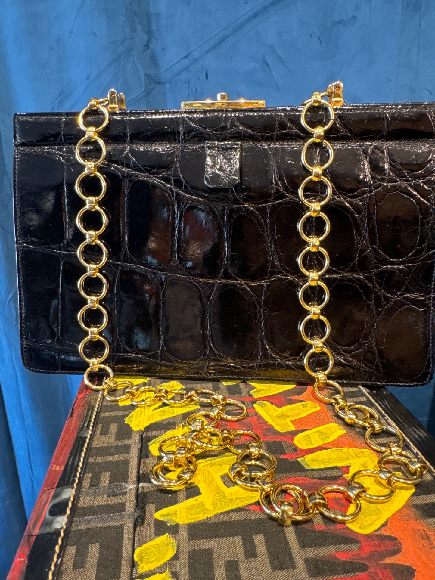 1960s vintage black alligator bag in beautiful condition, with lightweight gold shoulder chain. Original alligator top handle is inside bag. Made in France