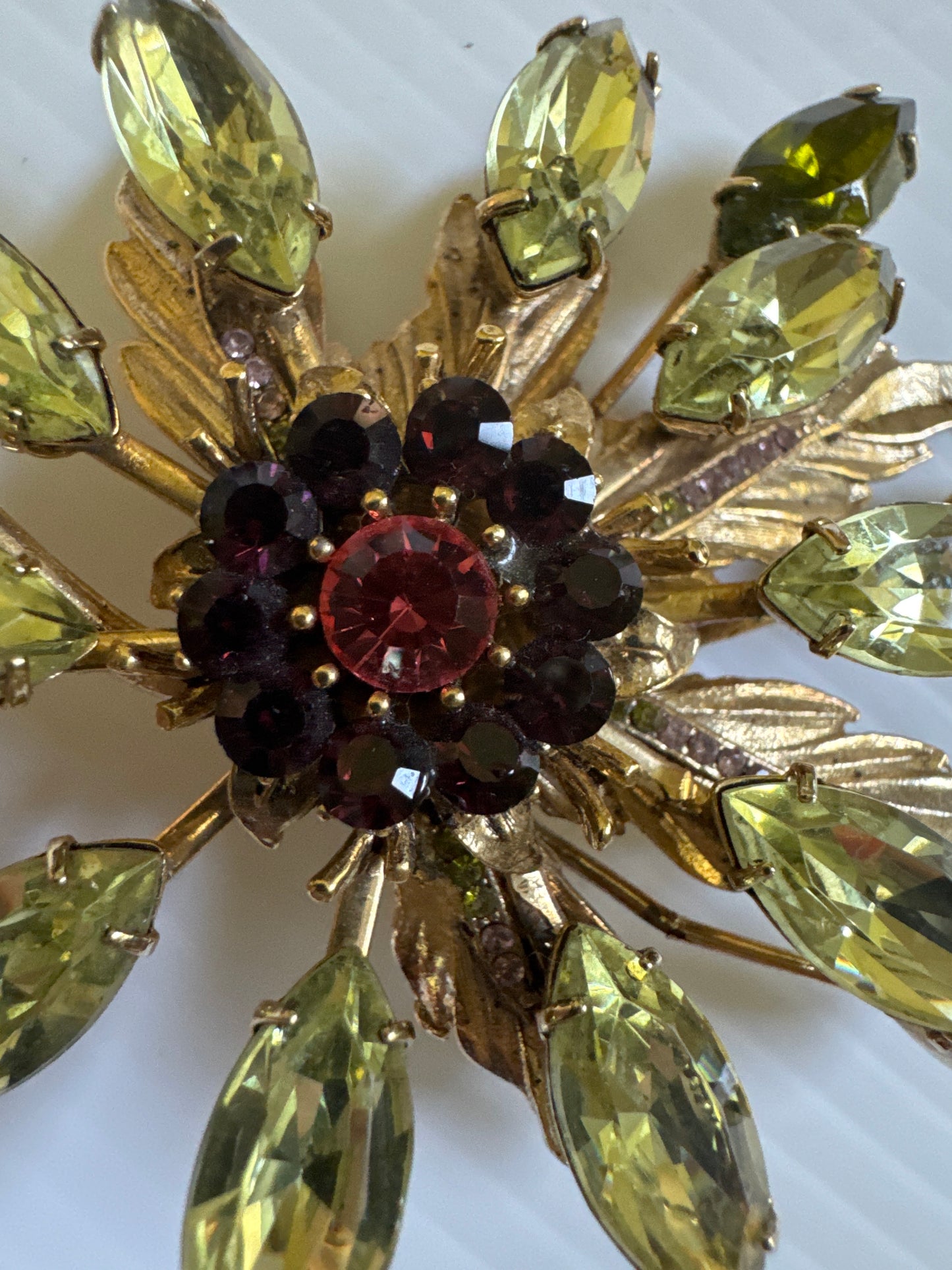Exquisite signed Graziano, gold tone brooch with green purple and pink rhinestones