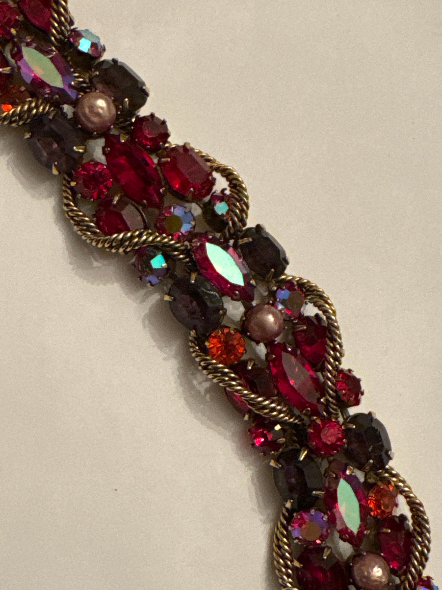 1950s signed KRAMER of NY rhinestone bracelet featuring red crystals and aurora borealis with a gold link chain throughout ￼