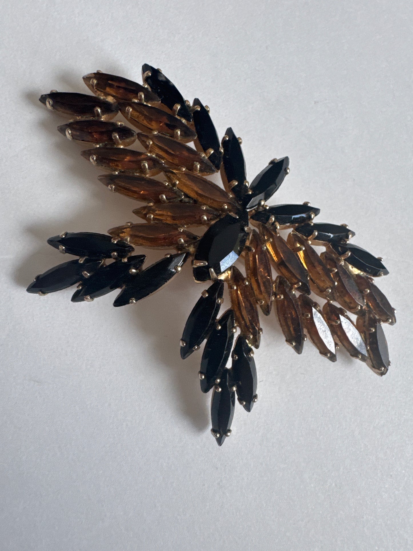 Beautiful 1950s D & E butterfly navette brooch featuring black and amber colored rhinestones