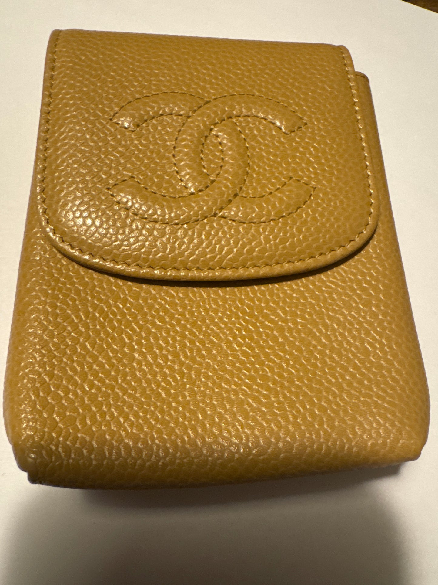 Beautiful tan caviar leather cigarette case, that can also be used for jewelry while traveling or at a chain to where as a cute Crossbody bag. Comes with authentication card.