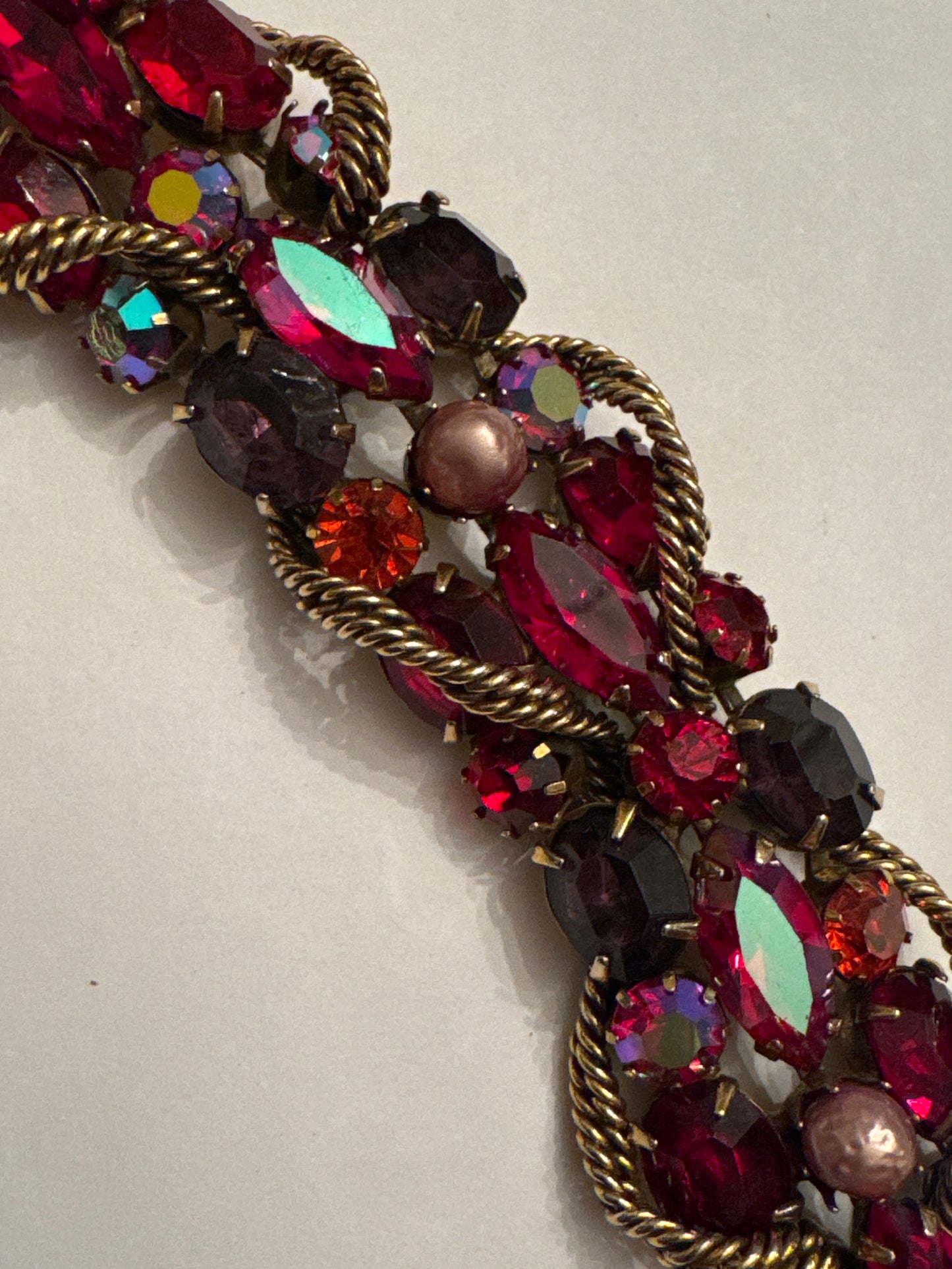 1950s signed KRAMER of NY rhinestone bracelet featuring red crystals and aurora borealis with a gold link chain throughout ￼