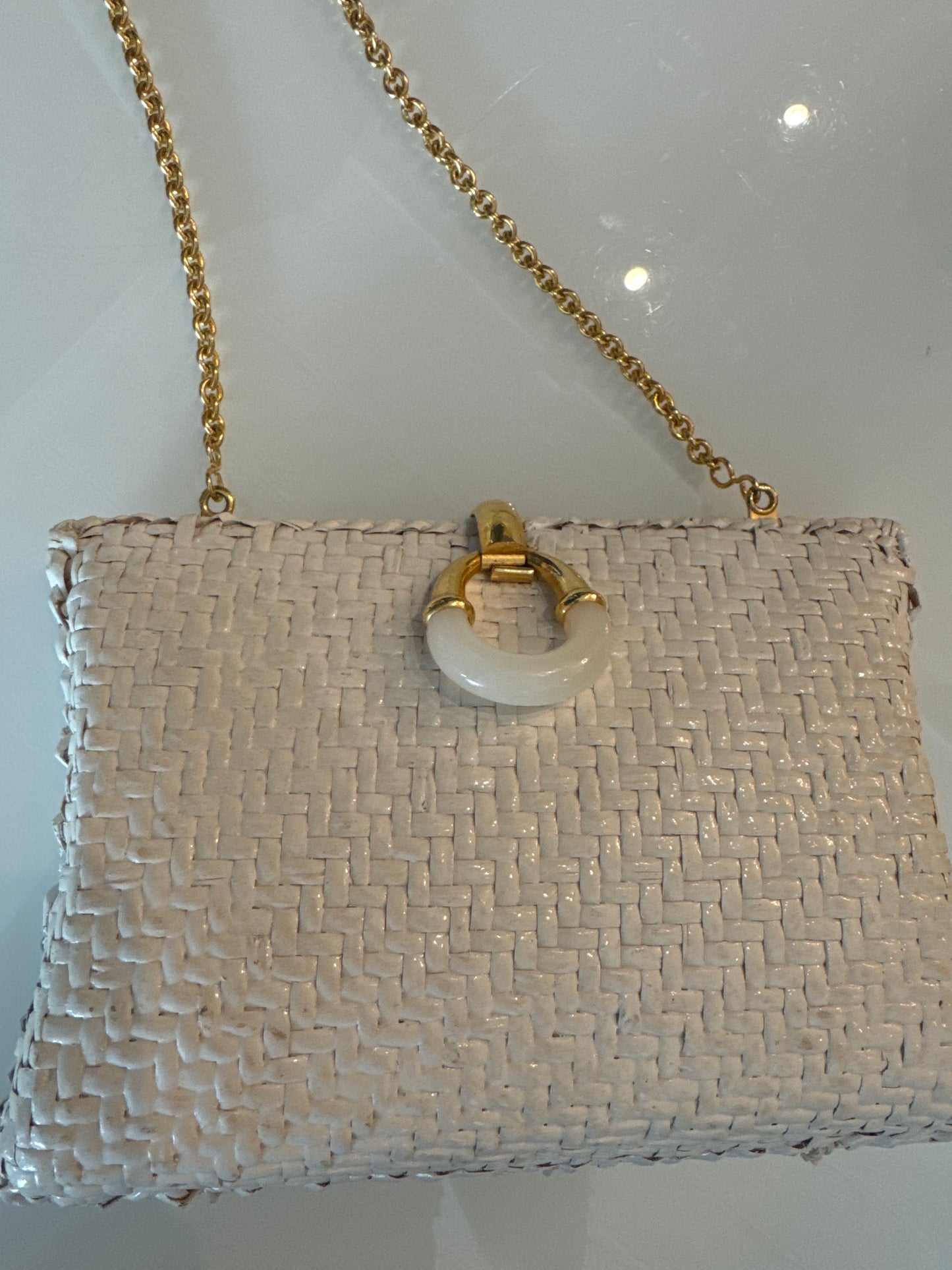 White rattan/wicker clutch with gold hardware and hidden shoulder strap