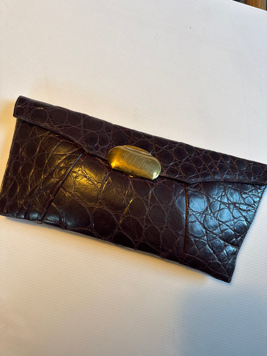 Vintage large 1940s dark burgundy brown alligator clutch handbag. It has a fold over closure with a gold toned metal clasp with monogram. maroon satin lining with pockets