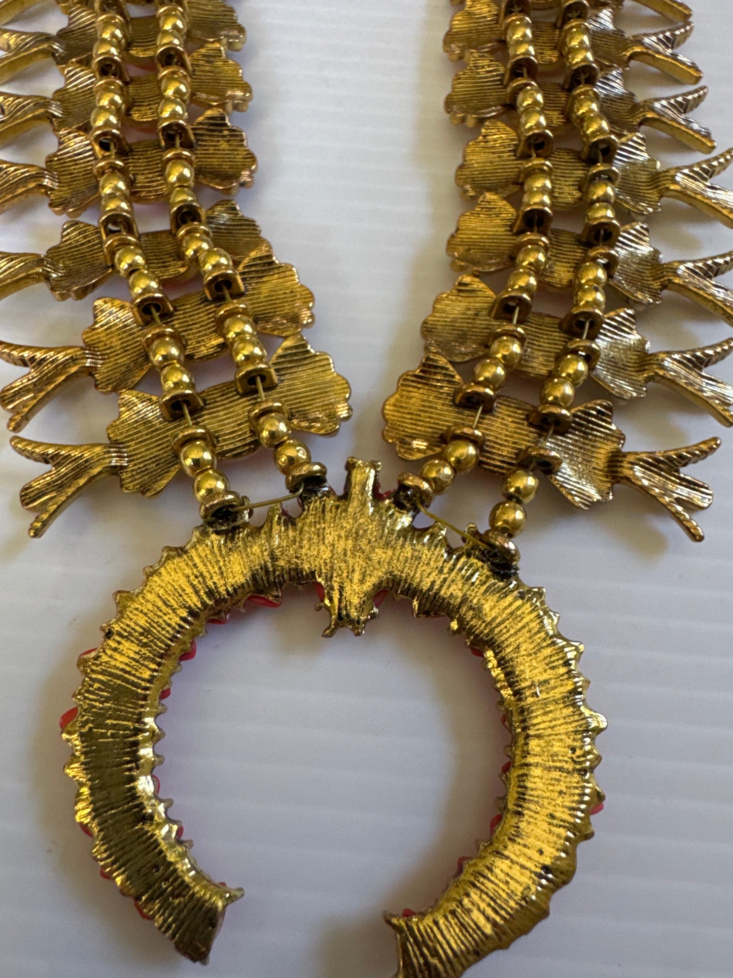 1990s adjustable squash blossom necklace in a gold tone setting with shades of coral stones