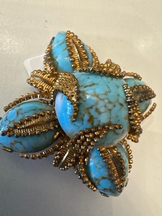 ￼Made in Austria, this beautiful brooch consist of blue marbleized cabochon glass