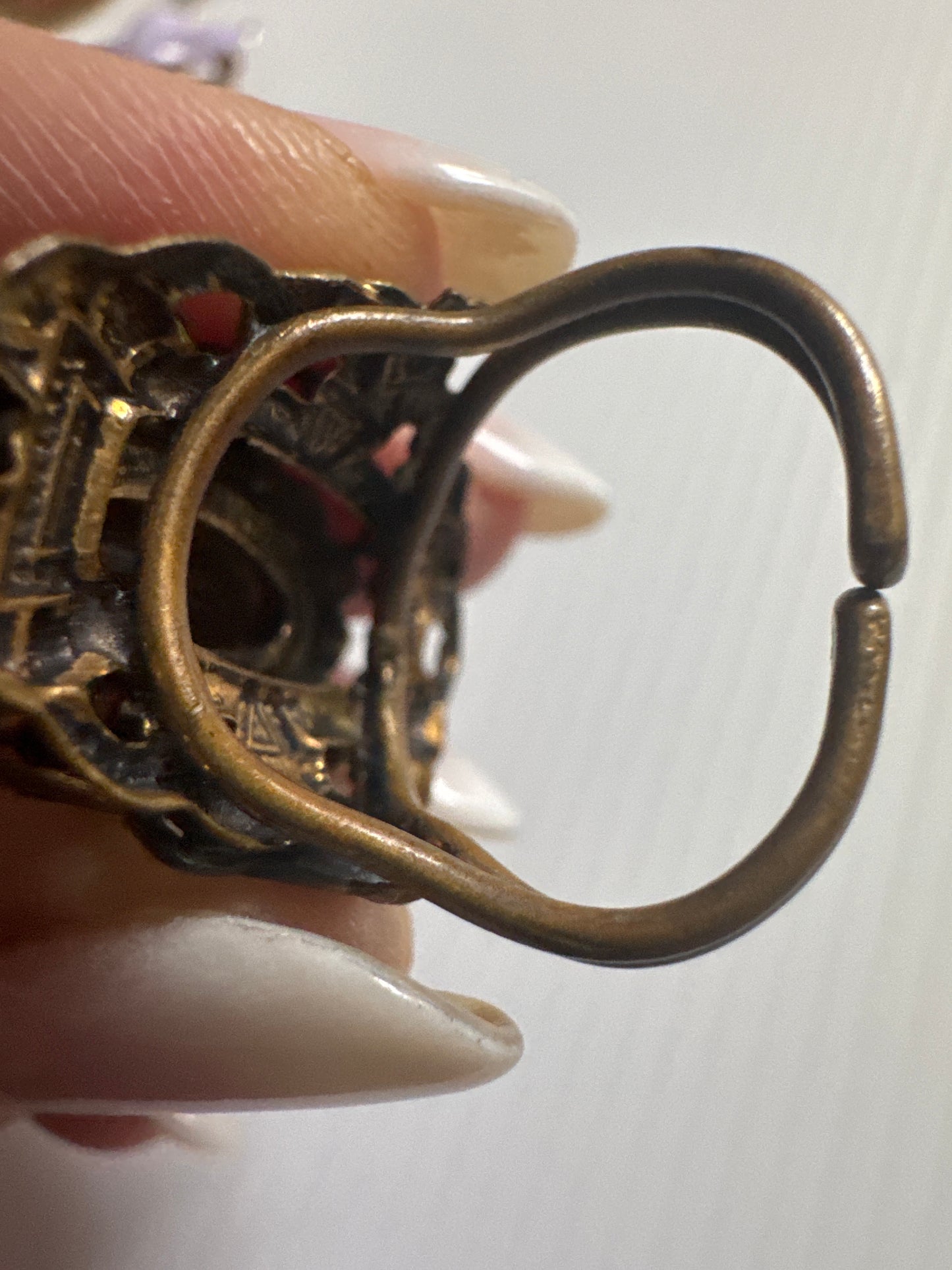 fabulous 1940s Czech glass ring with filigree detail, large green center stone and small green stones in setting