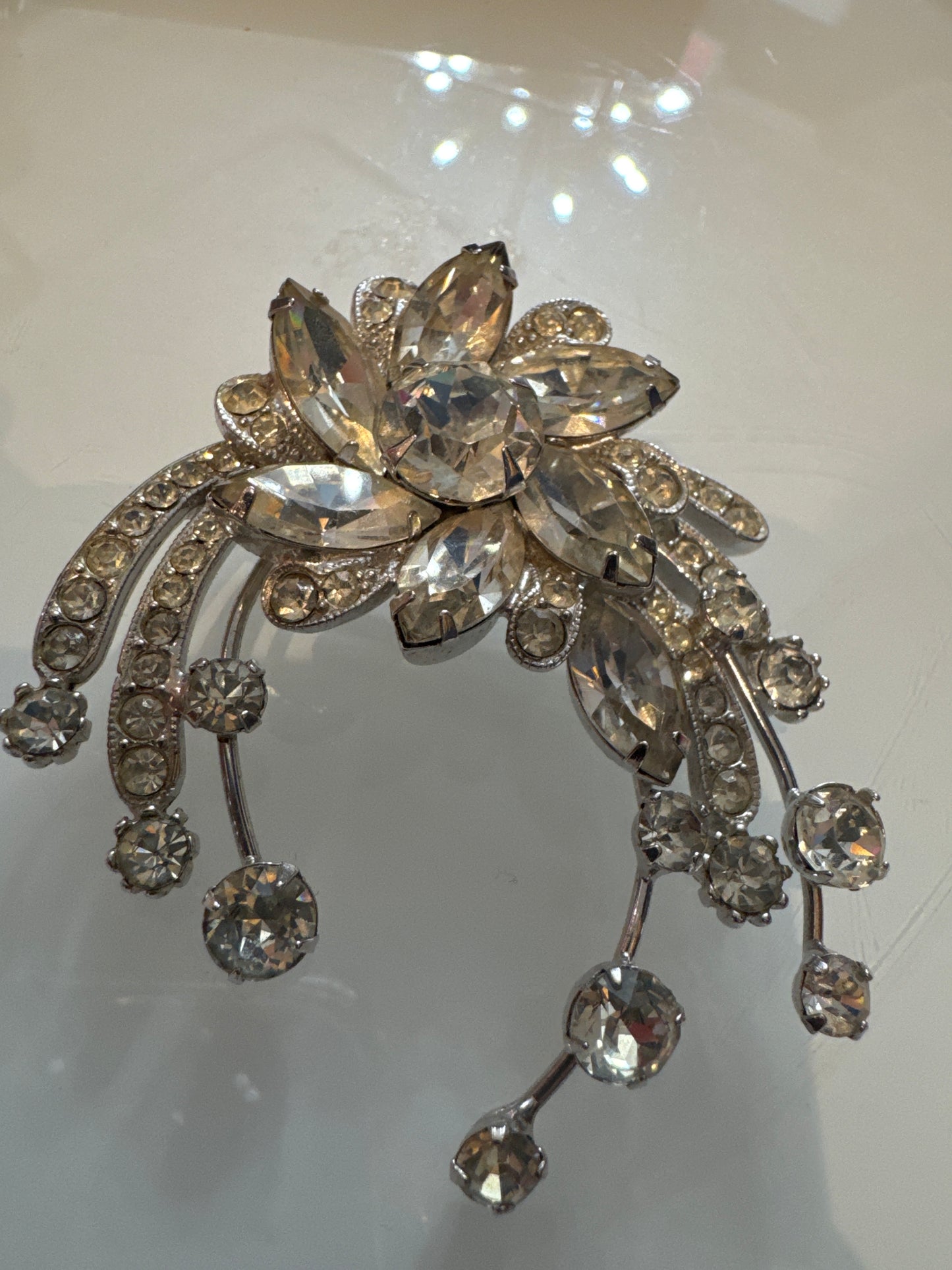 A dramatic mid-century Eisenberg Ice brooch featuring oversized marquise-cut crystals arranged in a radiant floral spray with cascading rhinestone drops. Crafted in rhodium-plated metal with exceptional brilliance and precision.