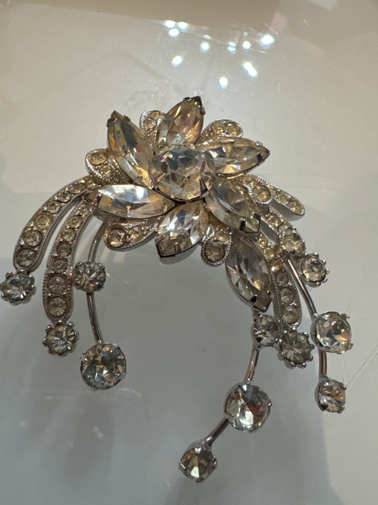 A dramatic mid-century Eisenberg Ice brooch featuring oversized marquise-cut crystals arranged in a radiant floral spray with cascading rhinestone drops. Crafted in rhodium-plated metal with exceptional brilliance and precision.