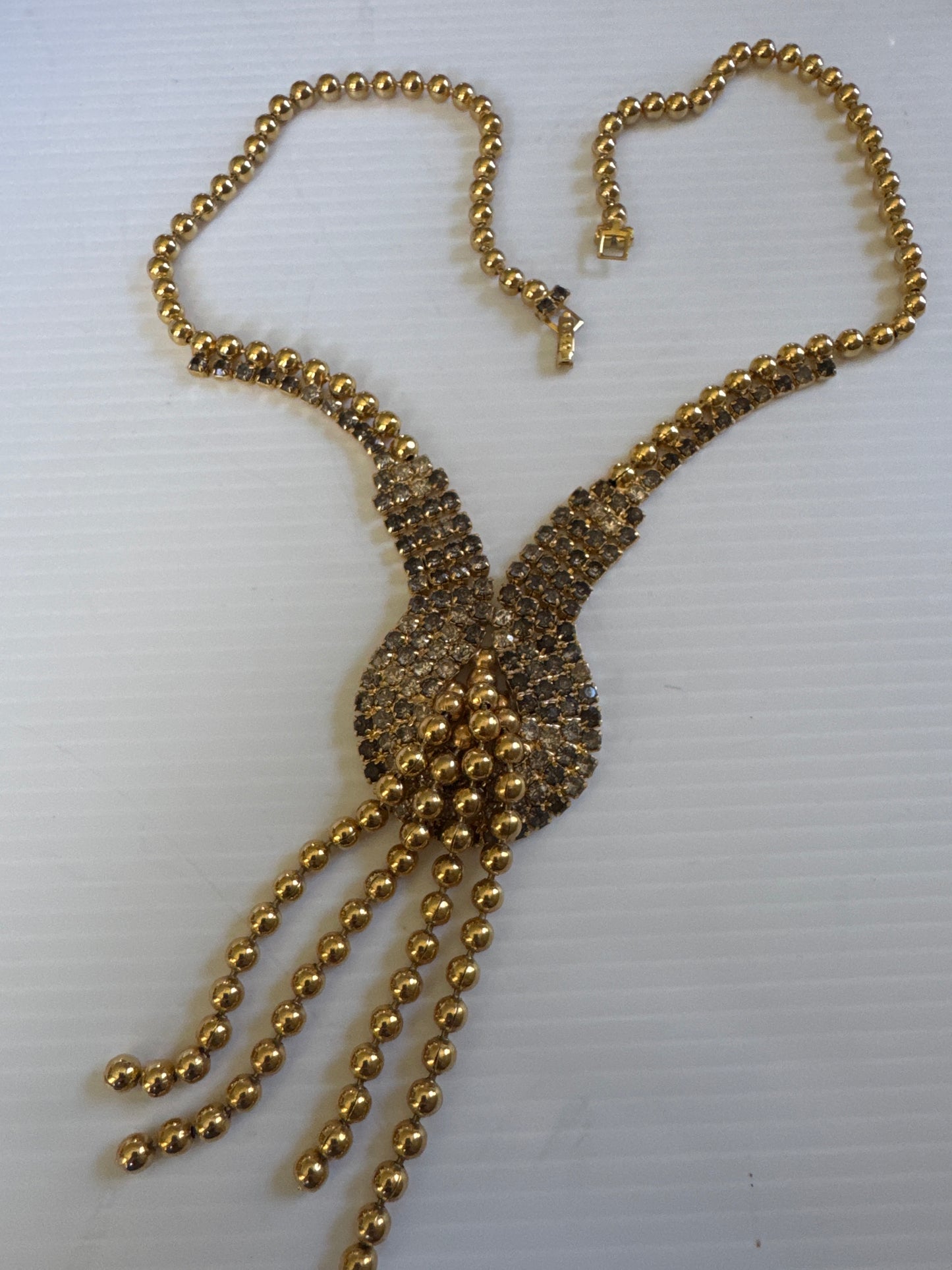 vintage necklace with gray and clear, rhinestones and gold tone ball tassel