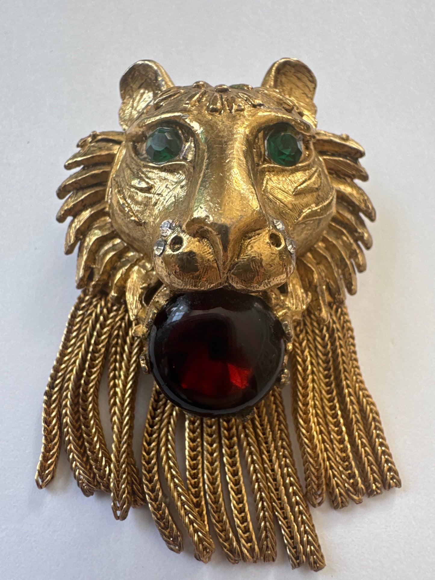 Coveted and hard to find 1960s unsigned lionhead tassel brooch attributed to Pauline Rader ~ this one being an amber glass cabochon with green rhinestone eyes. The wonderful coil fringe lions mane is fabulous.