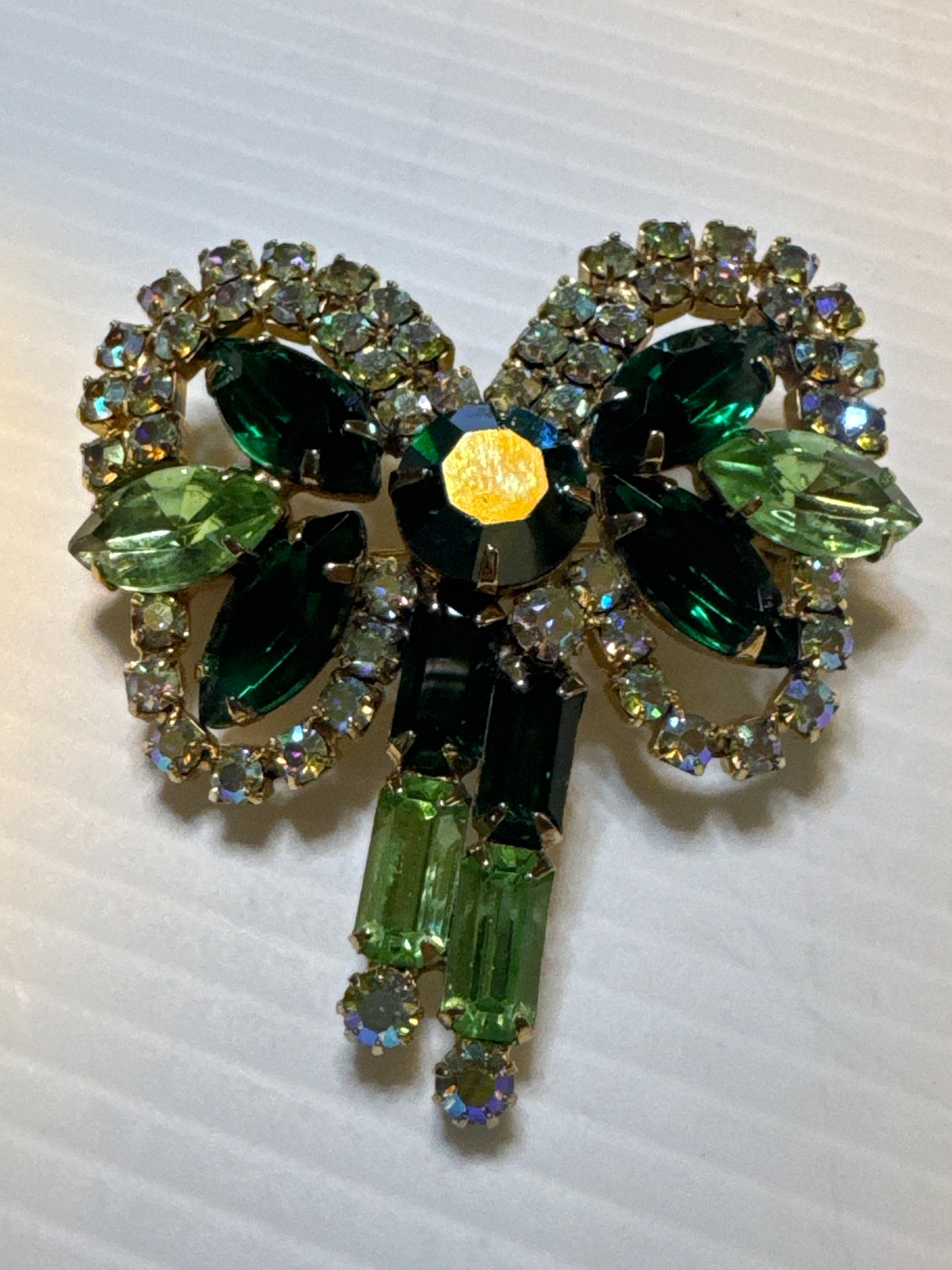 Beautiful 1950s shades of green bow brooch with aurora borealis