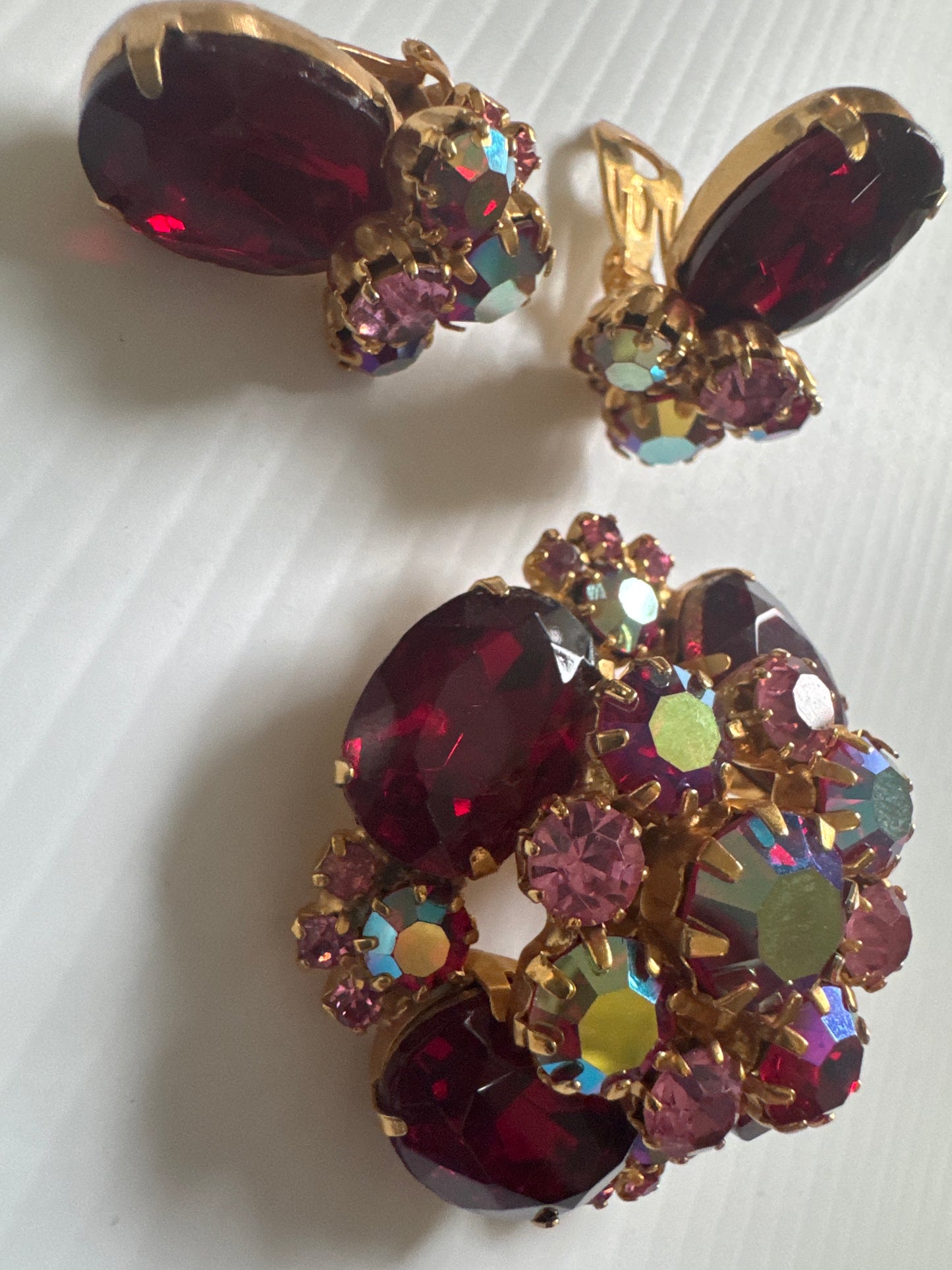 1950s stunning, brooch, and earrings set featuring red rhinestones and Aurora borealis