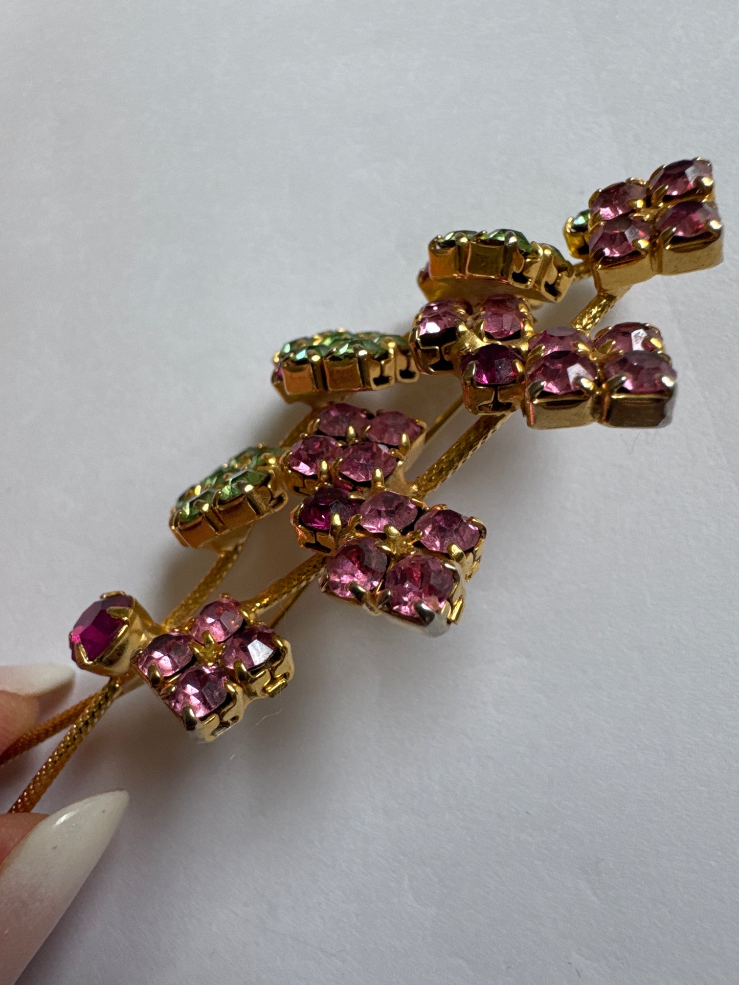Beautiful mid-century, floral spray, brooch featuring pink and green rhinestones on a gold tone back