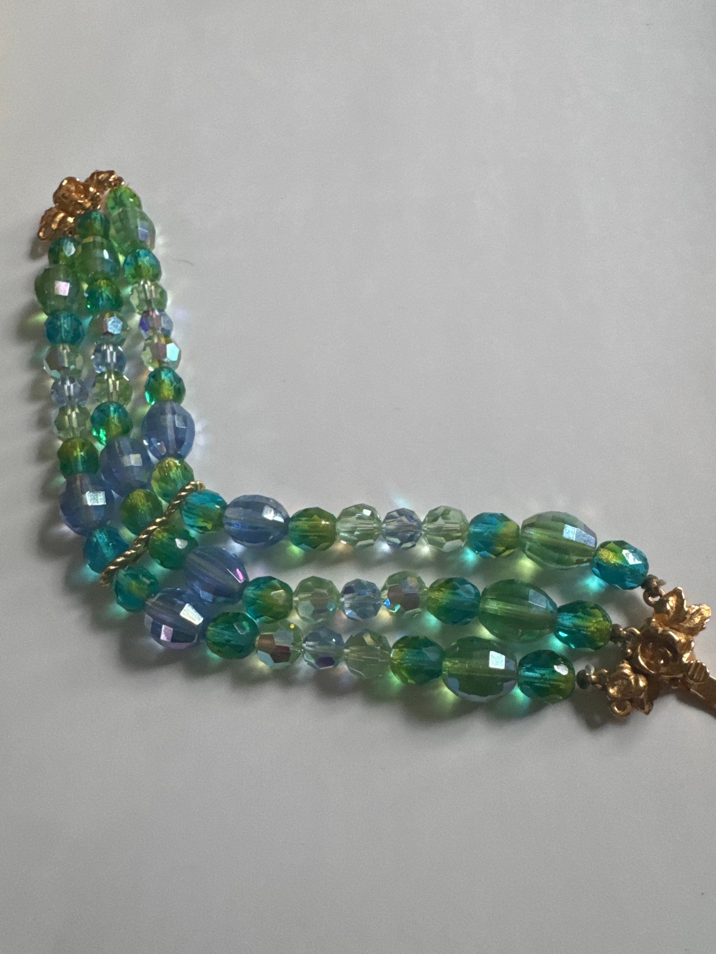 Unsigned attributed to Schiaparelli crystal bracelet with green and blue beads. Clasp points us in the direction of Schiaparelli along with the gradation of colors used.