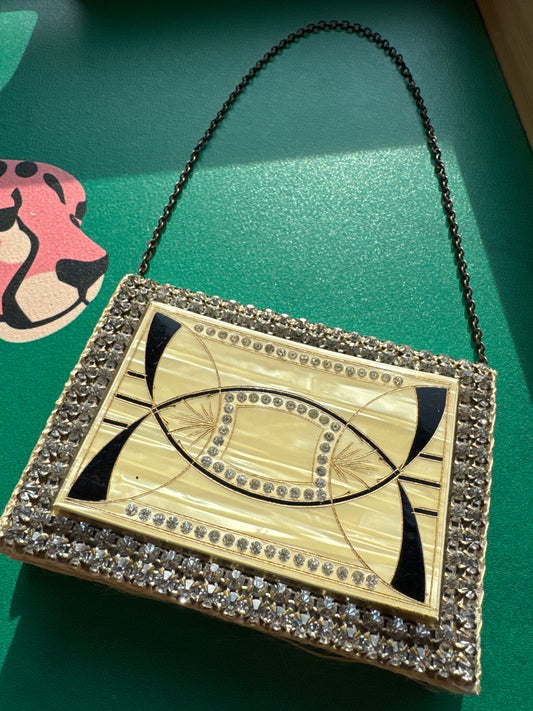Beautiful rhinestone and enamel art deco 1920s modernist mini minaudiere with chain. Celluloid with geometric in layers, give it the jazz age glamour. Over 100 years old!