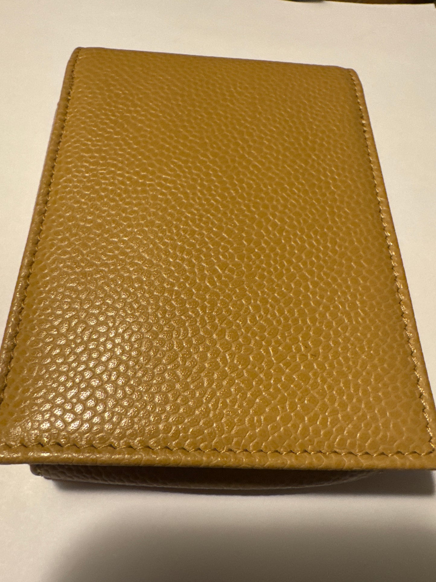 Beautiful tan caviar leather cigarette case, that can also be used for jewelry while traveling or at a chain to where as a cute Crossbody bag. Comes with authentication card.