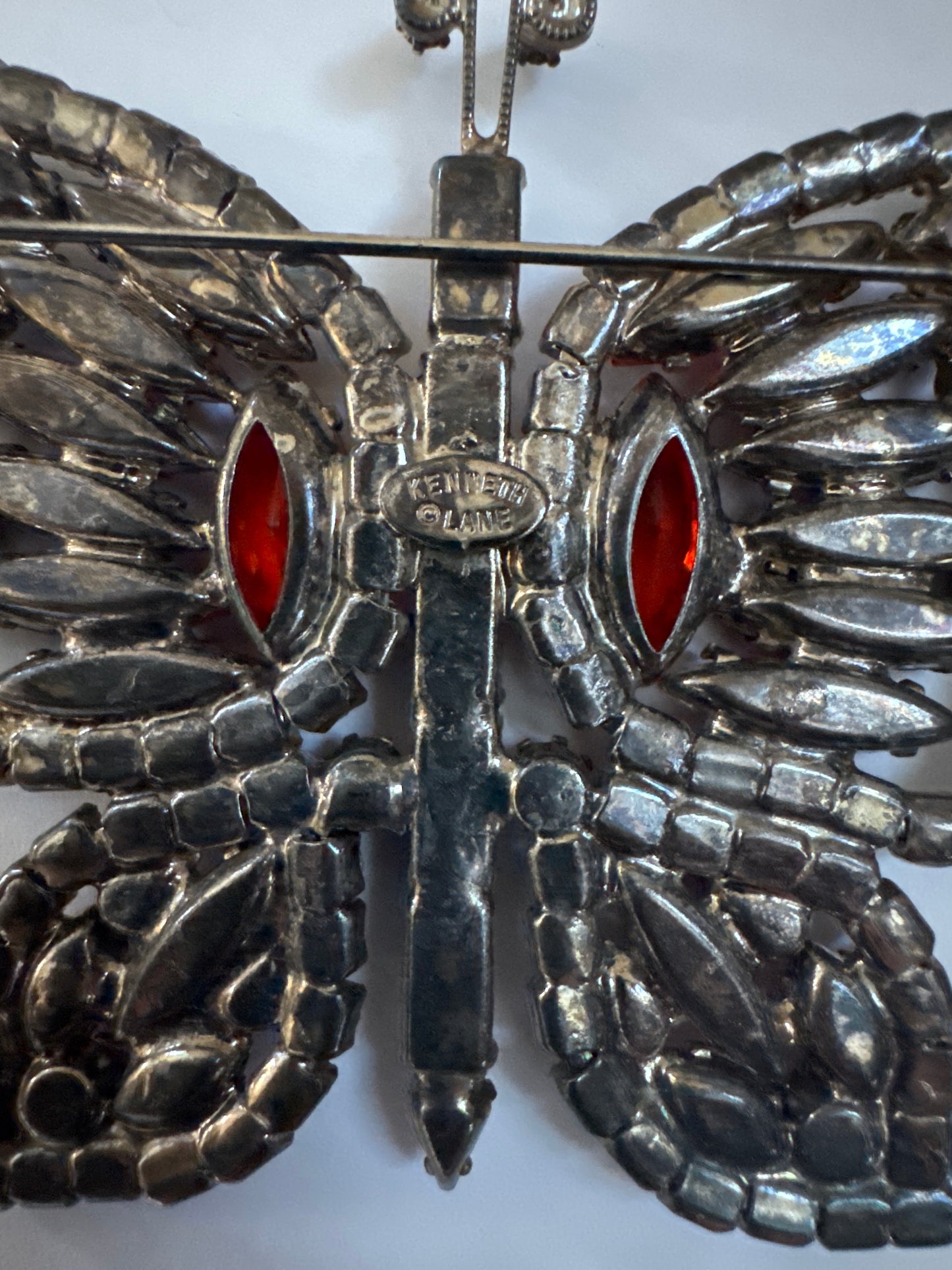 Late 1960s early 70s signed Kenneth Lane butterfly brooch featuring pink, orange and red rhinestones