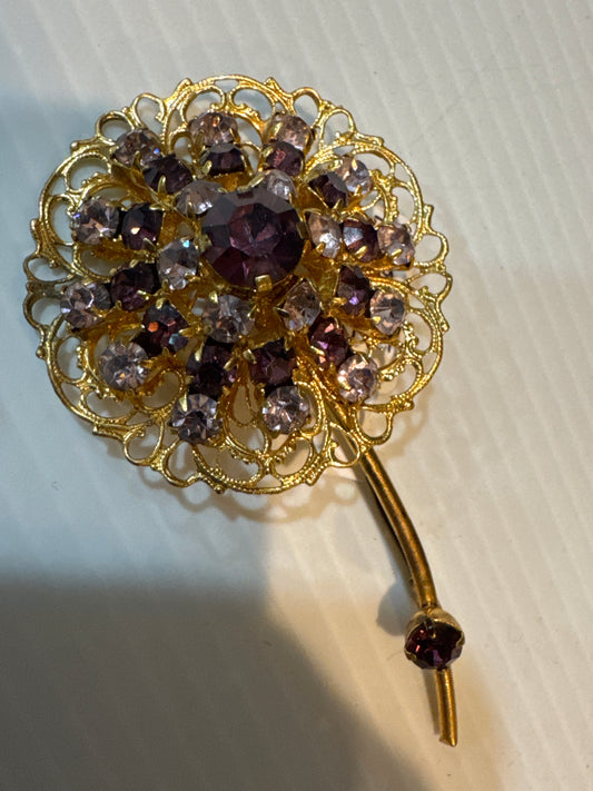 Beautiful vintage filigree flower brooch with dark and light purple stones and a special stone on the stem