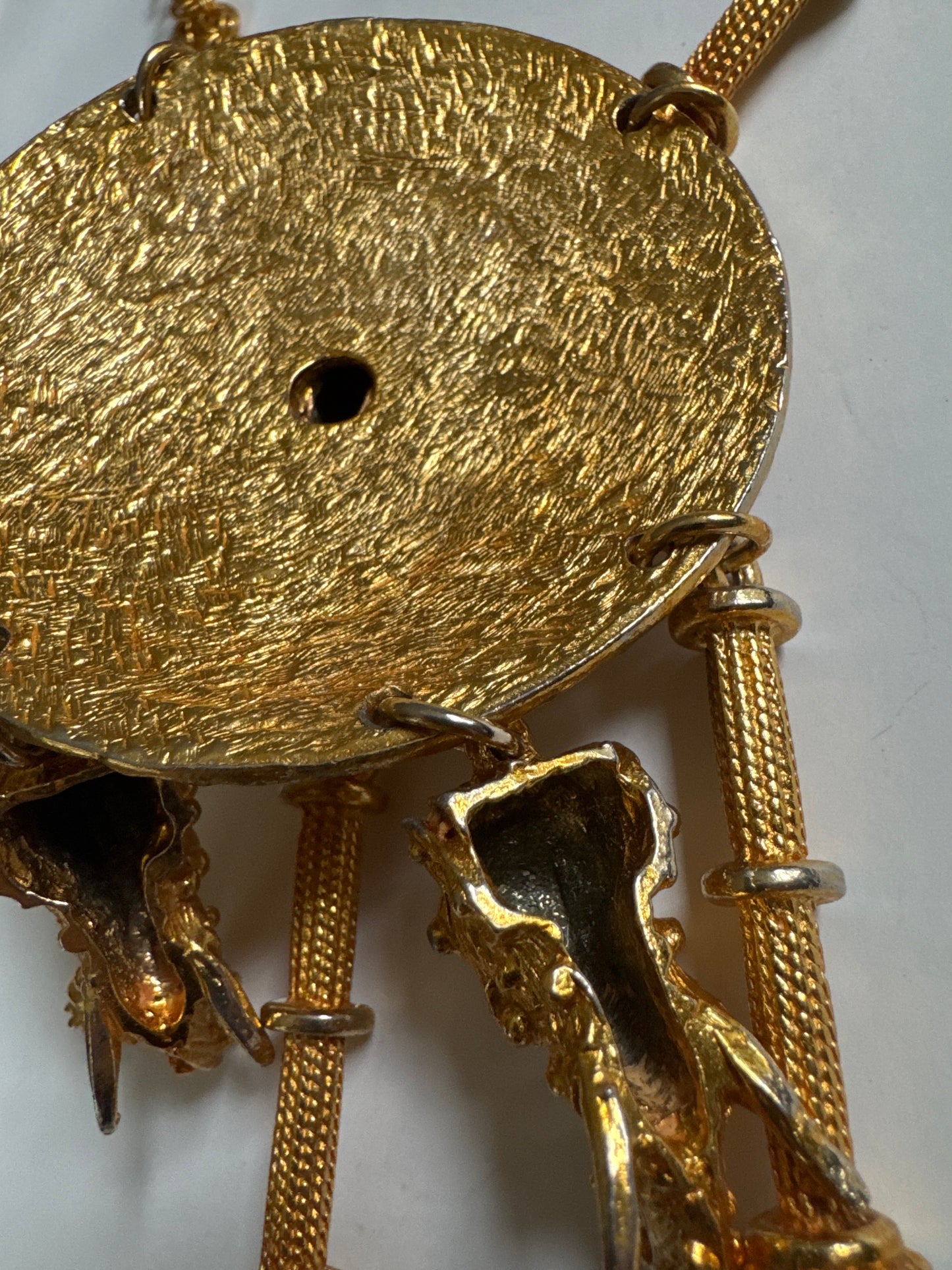Signed 1960s Pauline Rader signed gold tone necklace. The two elephant heads that dangle at the bottom of the pendant are hollow. Double chains on each side. It's heavy!