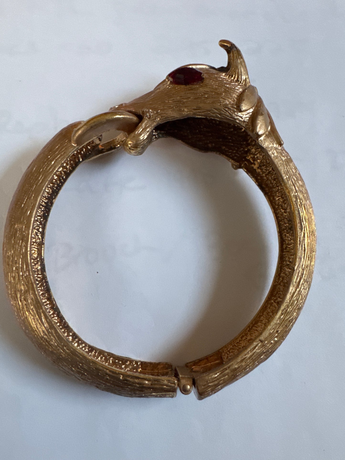 1960s signed PAULINE RADER gold tone ram clamper with ruby rhinestone eyes.