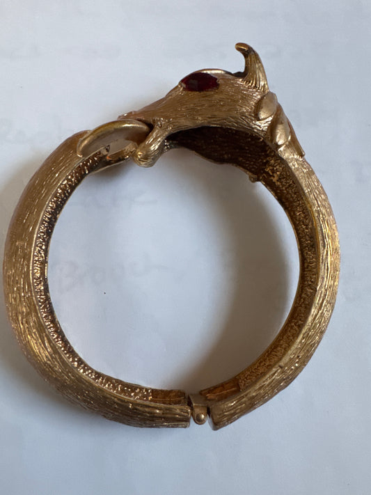 1960s signed PAULINE RADER gold tone ram clamper with ruby rhinestone eyes.