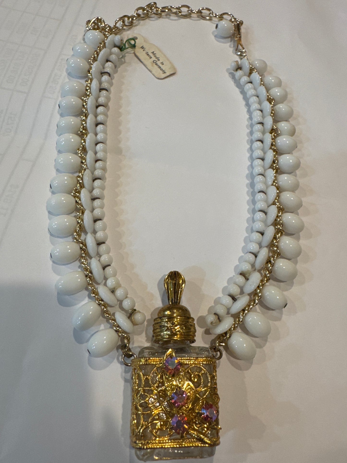 Beautiful 1940s/50s made in western Germany fragrance bottle necklace with white glass beads. Has original tag.