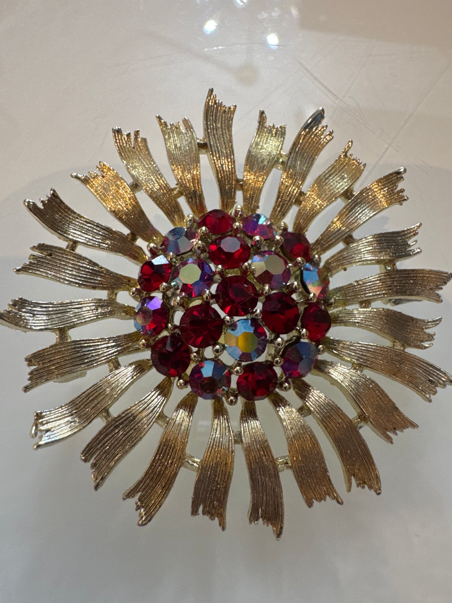 1950s signed LISNER starburst brooch with red rhinestones and aurora borealis