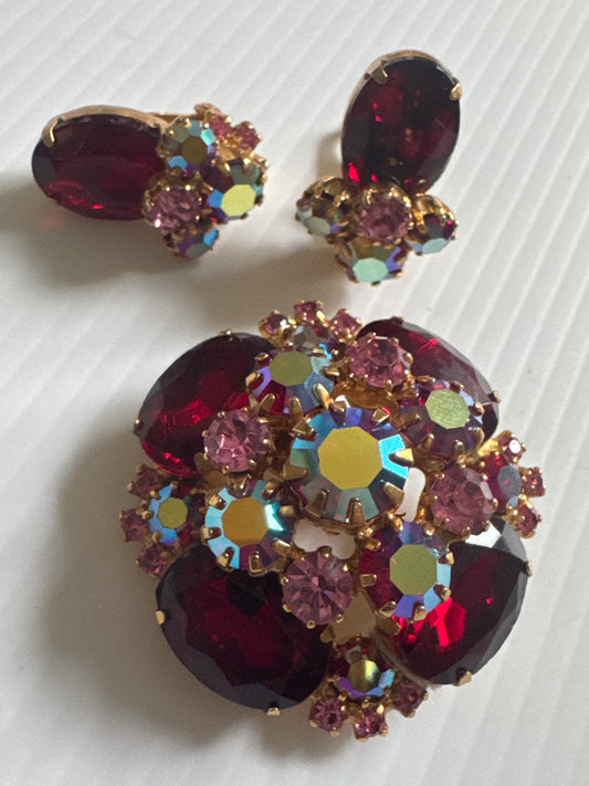 1950s stunning, brooch, and earrings set featuring red rhinestones and Aurora borealis