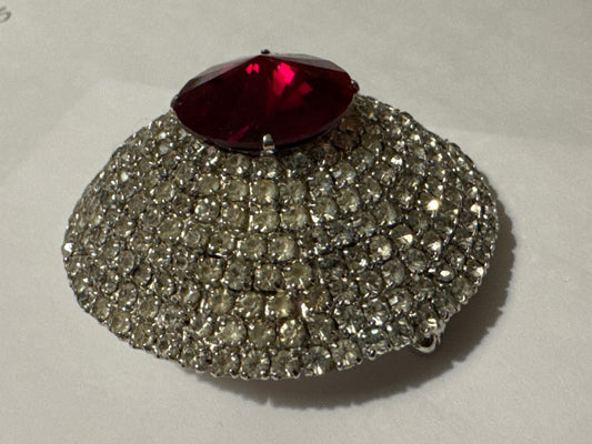 mid 1950s signed Hattie Carnegie pave dome brooch with Ruby red glass center, stone and hundreds of individually set pronged rhinestones
