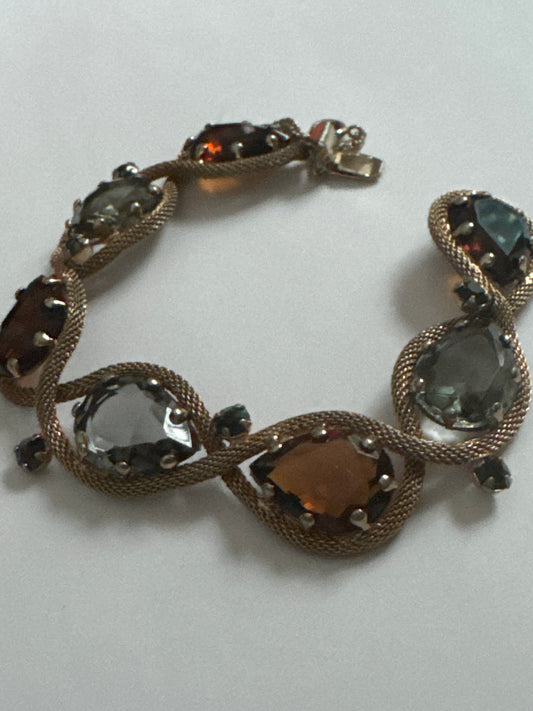 1950s signed HATTIE CARNAGIE smoky gray, and topaz bracelet with delicate gold tone rope motif  throughout