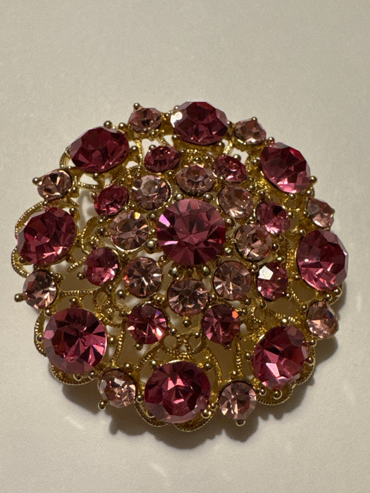 Pretty vintage pink and amethyst colored rhinestone brooch. Road
