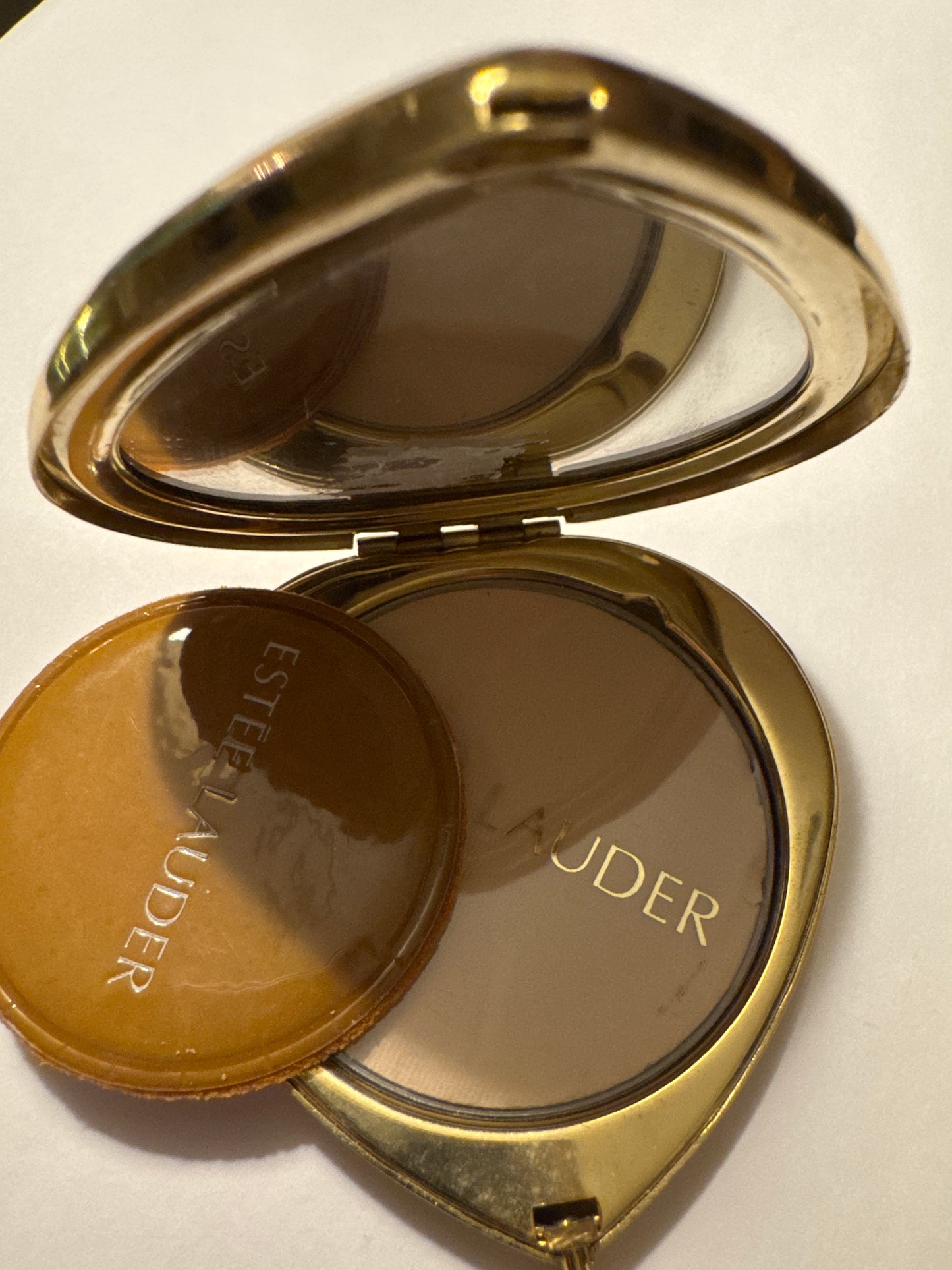 Vintage Estée Lauder powder gold tone heart compact with red stones. Road