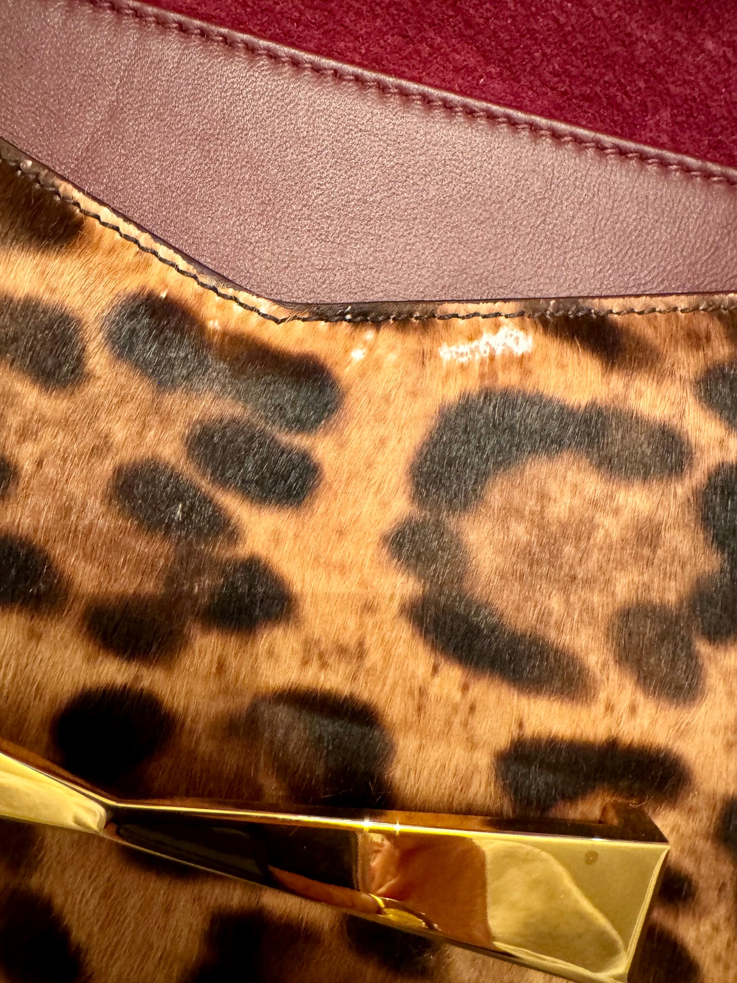 Alexander McQueen pony hair clutch with gold hardware, burgundy suede interior and gold hardware