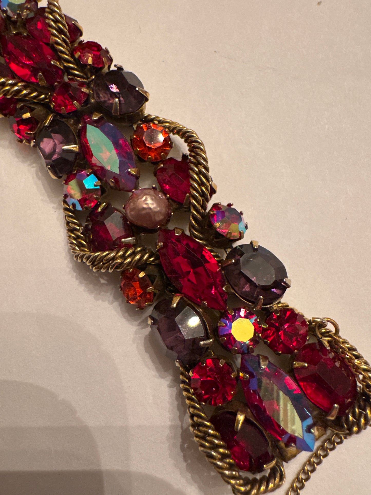 1950s signed KRAMER of NY rhinestone bracelet featuring red crystals and aurora borealis with a gold link chain throughout ￼