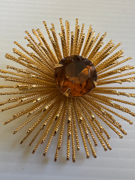 Vintage Sarah Coventry starburst brooch with amber colored stone