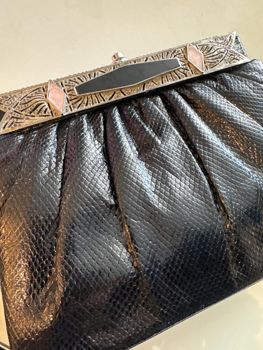 1980s gorgeous Black Judith Lieber with Art Deco, inspired and crusted jewels, including black and pink enamel and rhinestone detail. Silver attached shoulder chain.