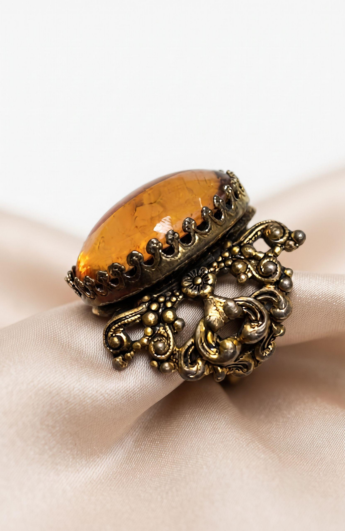 Beautiful peach colored lucite stone in filagree adjustable setting